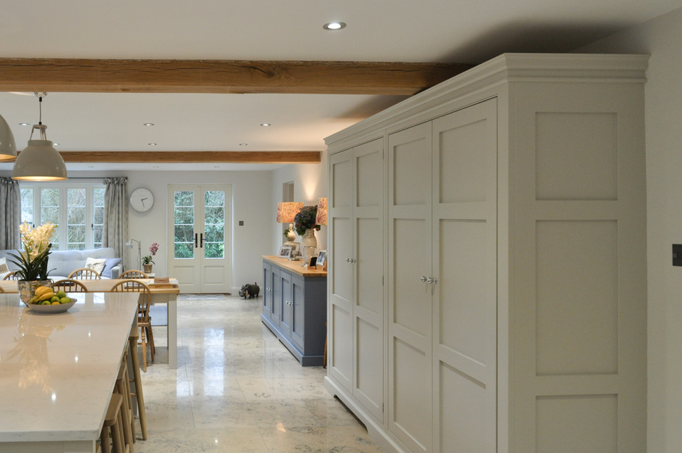 Photo of an expansive traditional l-shaped open plan kitchen in Other with a belfast sink, shaker cabinets, grey cabinets, quartz worktops, coloured appliances, limestone flooring and an island.