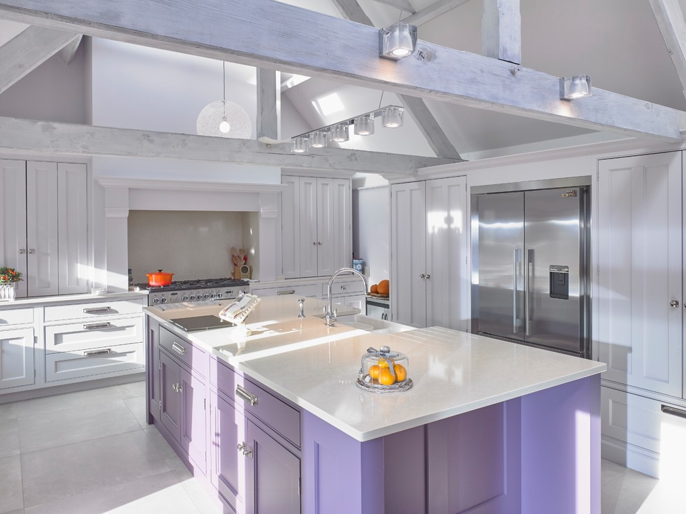 Example of a large classic single-wall porcelain tile and beige floor eat-in kitchen design in Cheshire with a farmhouse sink, recessed-panel cabinets, purple cabinets, quartzite countertops, beige backsplash, stainless steel appliances, an island and beige countertops