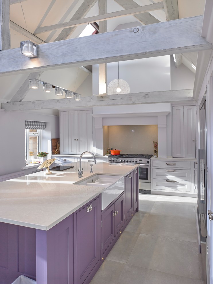 Photo of a large classic single-wall kitchen/diner in Cheshire with a belfast sink, recessed-panel cabinets, purple cabinets, quartz worktops, beige splashback, stainless steel appliances, porcelain flooring, an island, beige floors and beige worktops.
