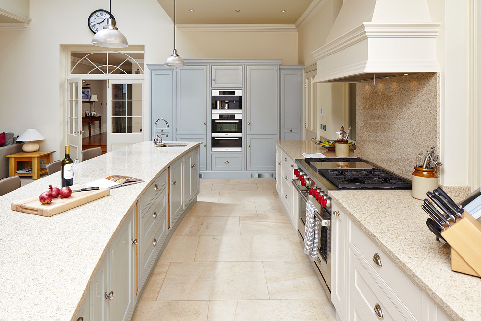 Photo of a classic kitchen in Other with a submerged sink, recessed-panel cabinets, beige splashback, stainless steel appliances and an island.