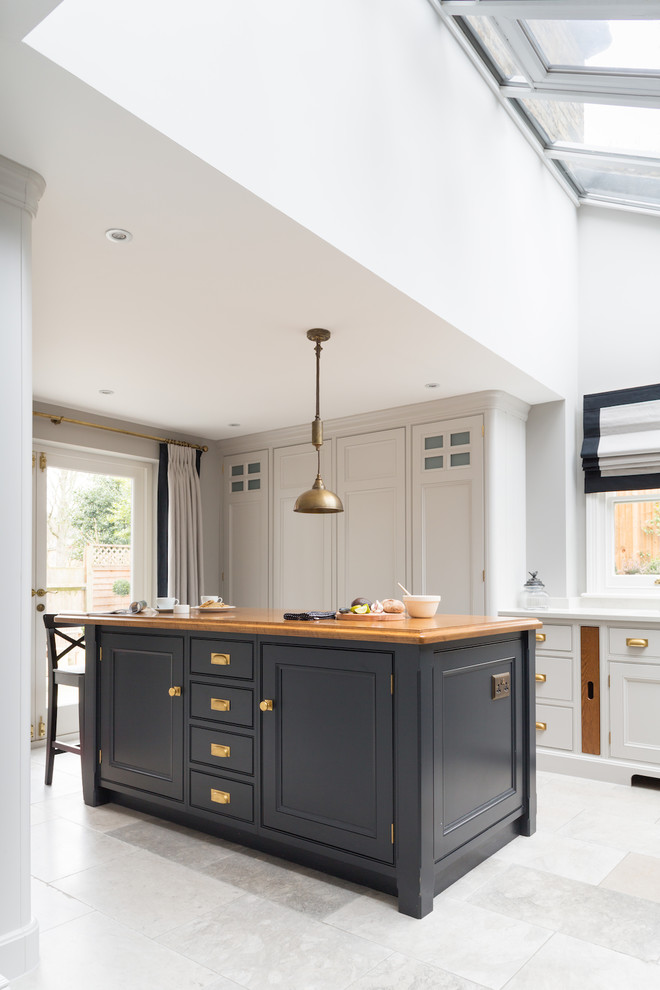 This is an example of a medium sized classic u-shaped kitchen in London.