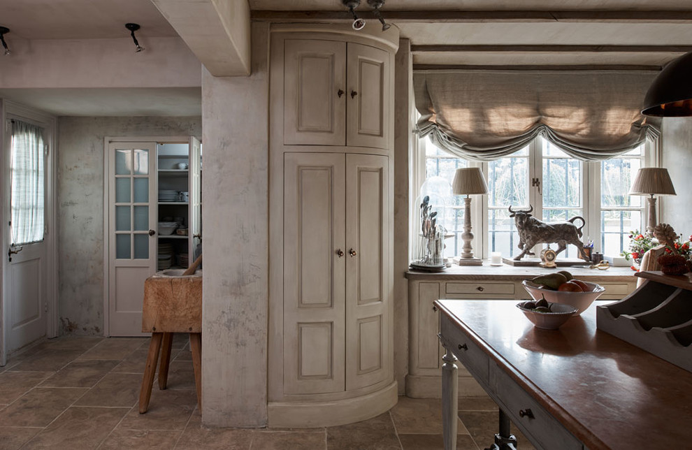 This is an example of a rustic kitchen in London with limestone worktops.