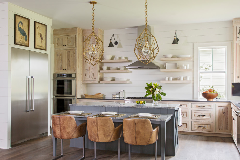 Design ideas for a beach style u-shaped kitchen/diner in Charleston with shaker cabinets, light wood cabinets, white splashback, wood splashback, stainless steel appliances, medium hardwood flooring, an island, brown floors and grey worktops.