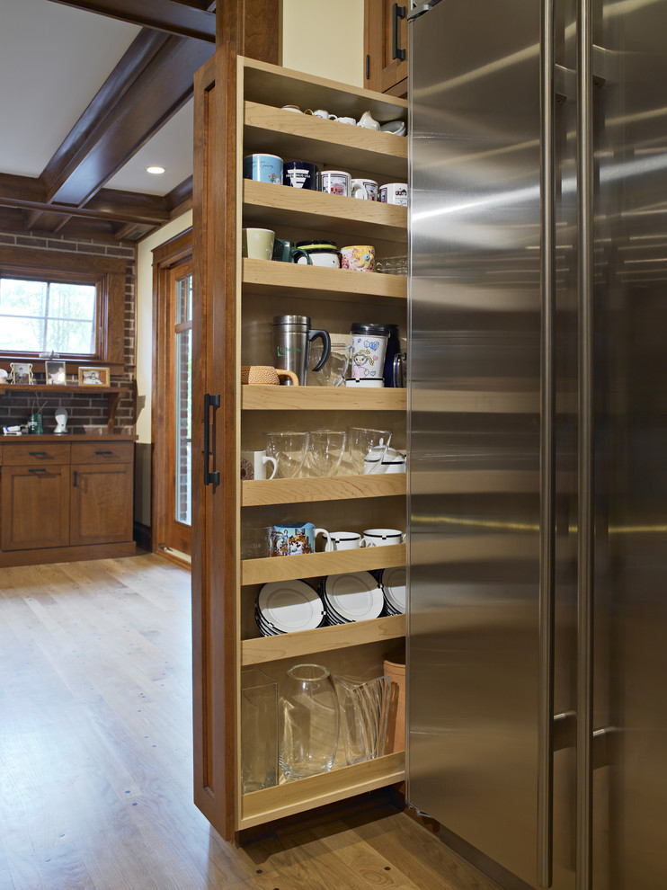 Elegant kitchen photo in Chicago with medium tone wood cabinets and recessed-panel cabinets