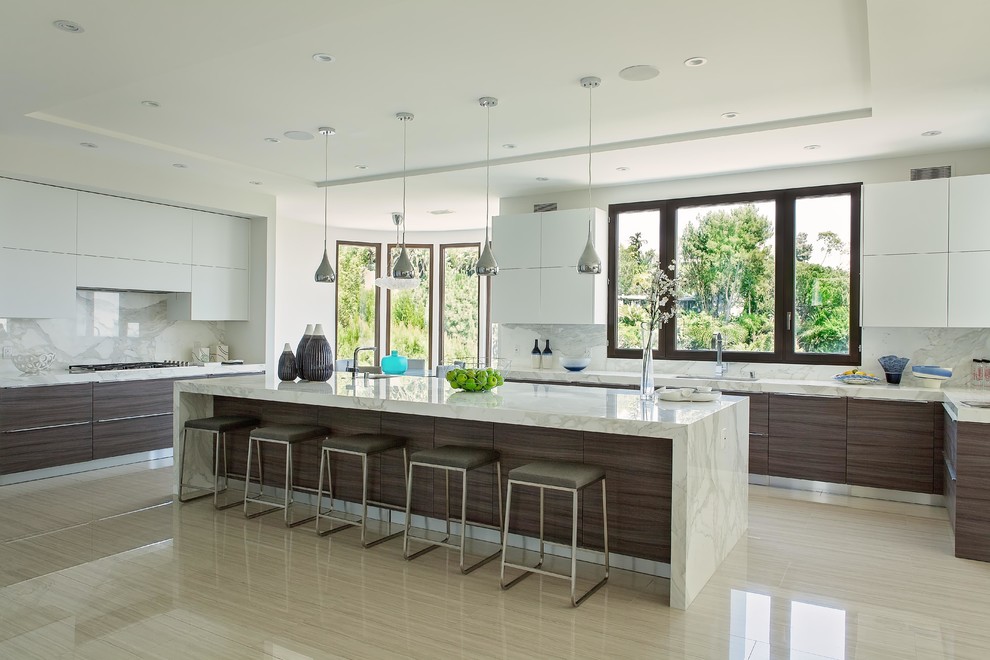 Große Moderne Küche in U-Form mit flächenbündigen Schrankfronten, weißen Schränken, Küchenrückwand in Weiß, Rückwand aus Stein und Kücheninsel in Los Angeles