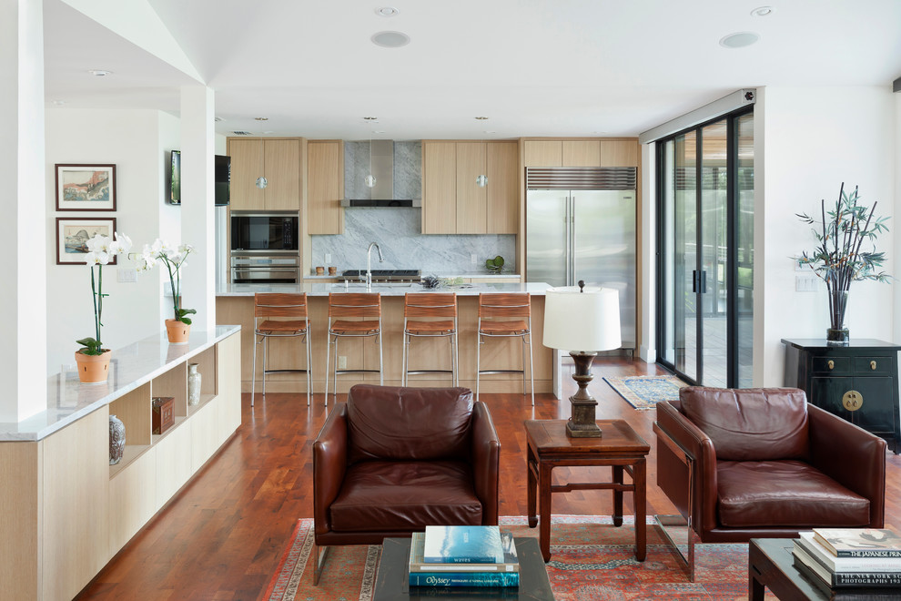 Design ideas for a contemporary galley open plan kitchen in Austin with flat-panel cabinets, light wood cabinets and a breakfast bar.