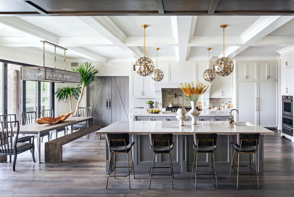 Mediterranean kitchen/diner in Los Angeles with a submerged sink, shaker cabinets, white cabinets, brown splashback, stainless steel appliances, dark hardwood flooring, multiple islands, brown floors, white worktops and a coffered ceiling.
