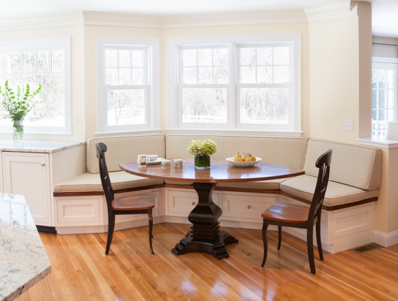 Example of a classic u-shaped eat-in kitchen design in Boston with an undermount sink, beaded inset cabinets, white cabinets, granite countertops, white backsplash, porcelain backsplash and stainless steel appliances