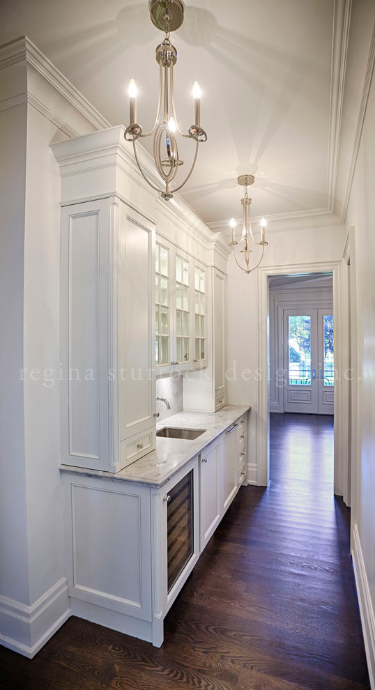 Large traditional kitchen pantry in Toronto with a submerged sink, recessed-panel cabinets, white cabinets, quartz worktops, mosaic tiled splashback, integrated appliances, medium hardwood flooring and an island.