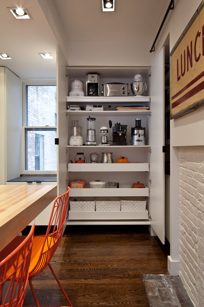 Photo of a contemporary kitchen in Boston with wood worktops, flat-panel cabinets, white cabinets and stainless steel appliances.