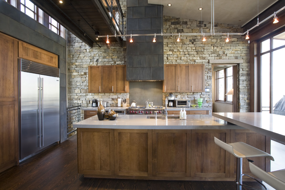 Urban kitchen photo in Denver with stainless steel appliances, shaker cabinets, dark wood cabinets and an undermount sink