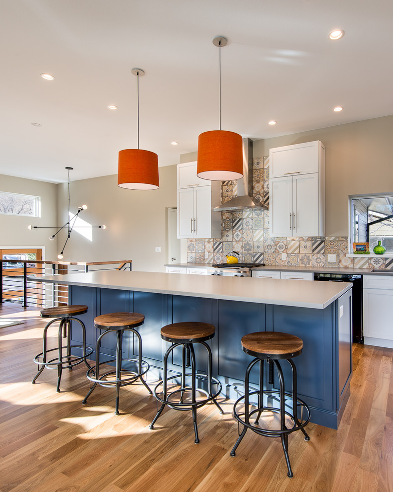 Inspiration for a mid-sized contemporary l-shaped light wood floor eat-in kitchen remodel in Denver with an undermount sink, shaker cabinets, yellow cabinets, quartz countertops, multicolored backsplash, porcelain backsplash, stainless steel appliances and an island