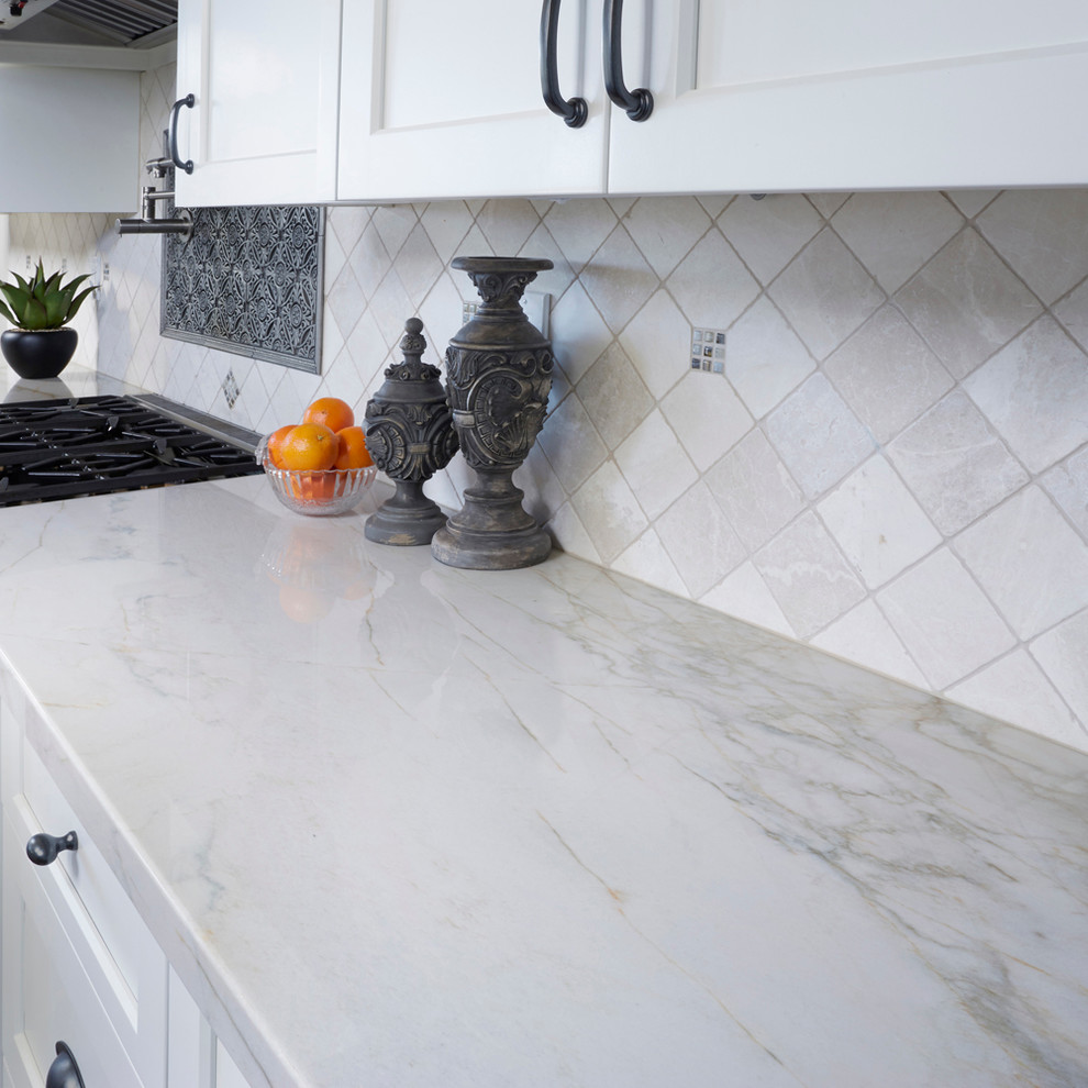 Large kitchen photo in San Diego with marble countertops, stone tile backsplash, white backsplash and white countertops