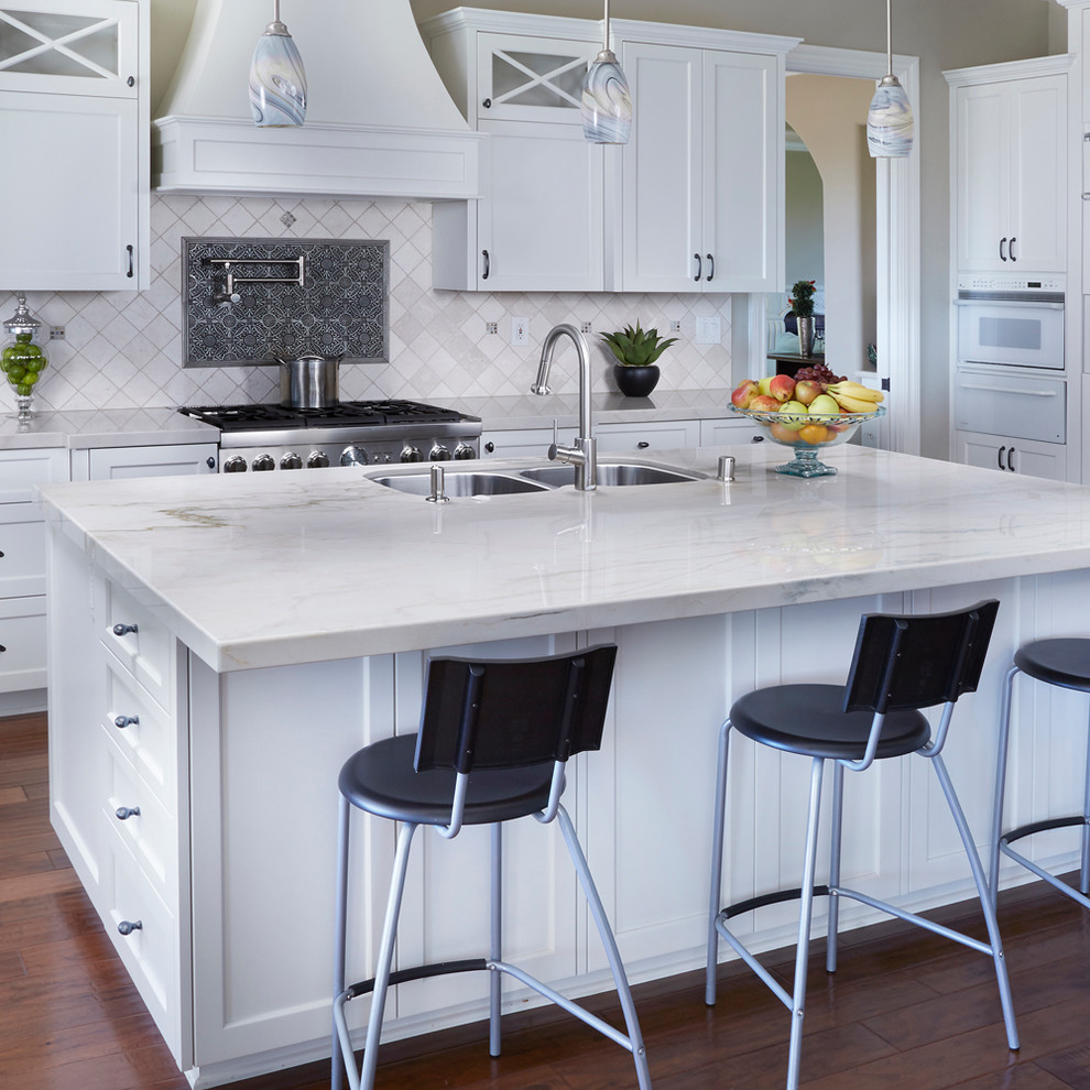 Inspiration for a large modern eat-in kitchen remodel in San Diego with marble countertops, stone tile backsplash, a double-bowl sink, white backsplash, an island and white countertops