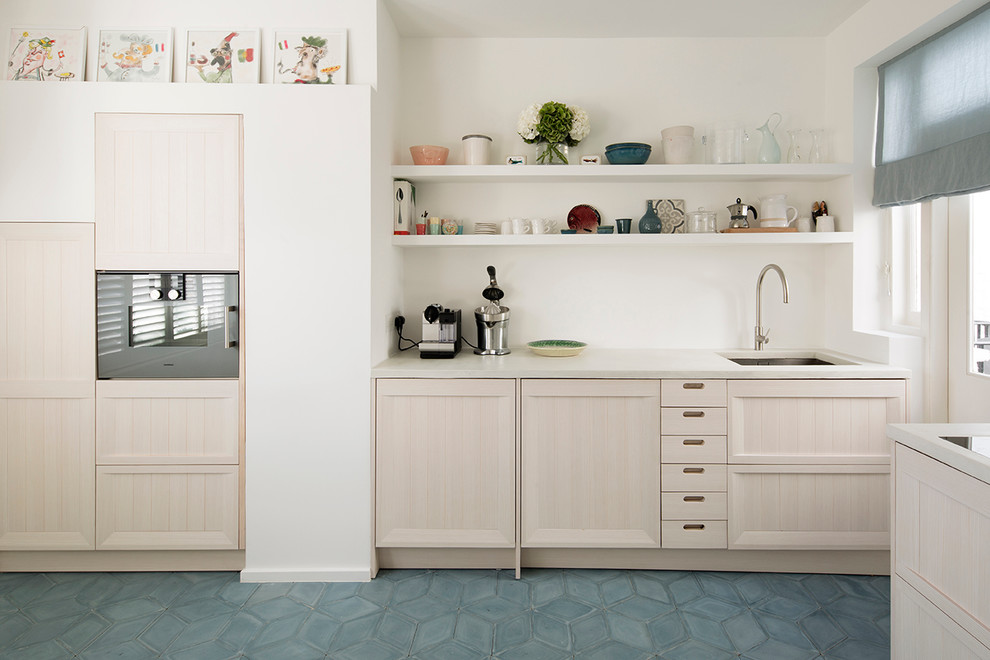 Medium sized scandinavian galley kitchen/diner in London with a built-in sink, beaded cabinets, light wood cabinets, concrete worktops, white splashback, cement tile splashback, stainless steel appliances, cement flooring, no island and blue floors.