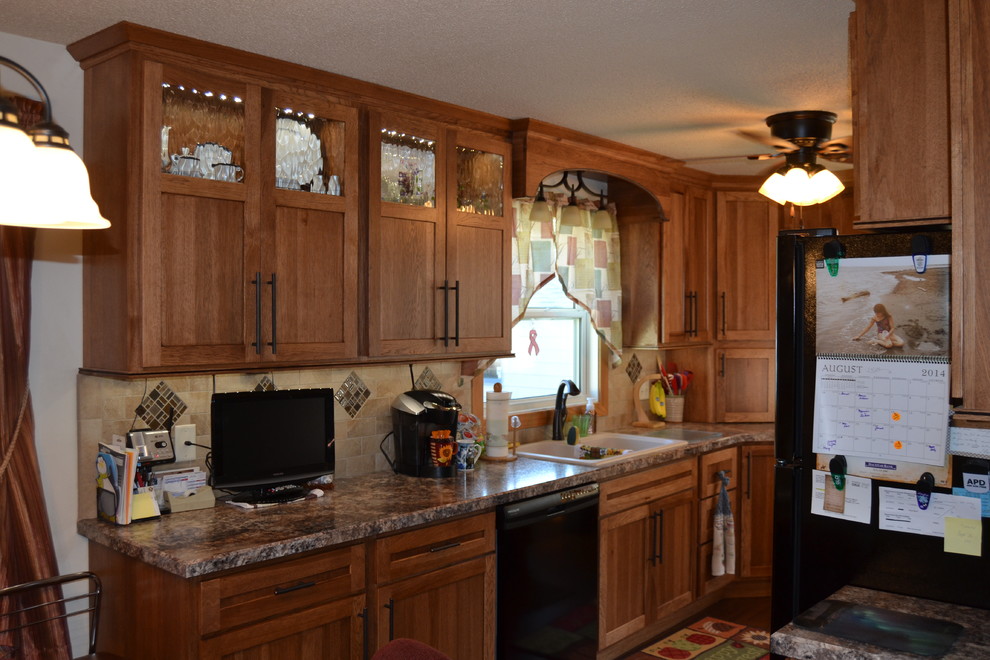 This is an example of a medium sized traditional u-shaped kitchen/diner in Baltimore with a double-bowl sink, flat-panel cabinets, black cabinets, laminate countertops, beige splashback, ceramic splashback and stainless steel appliances.