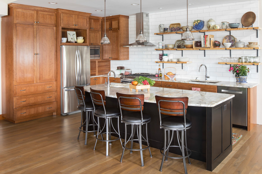 Large transitional l-shaped medium tone wood floor kitchen photo in Minneapolis with granite countertops, white backsplash, stainless steel appliances, an island, a double-bowl sink, open cabinets and subway tile backsplash