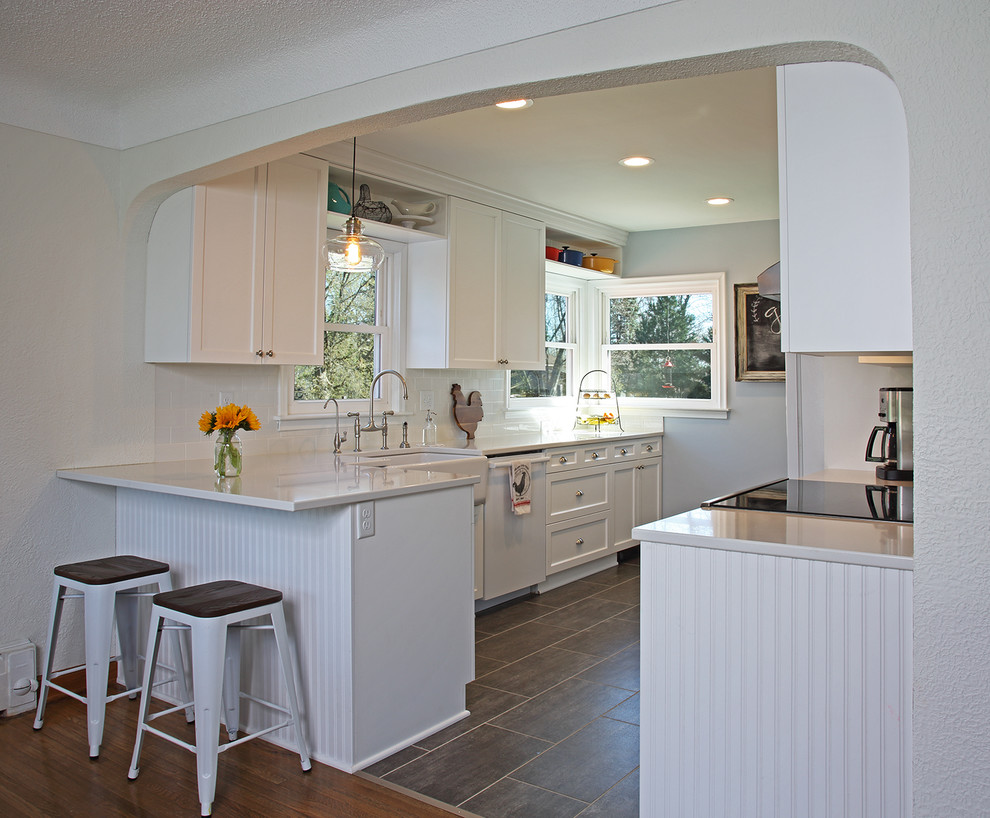 Inspiration for a small country galley vinyl floor and brown floor enclosed kitchen remodel in Minneapolis with a farmhouse sink, recessed-panel cabinets, white cabinets, gray backsplash, ceramic backsplash, white appliances, no island and quartzite countertops