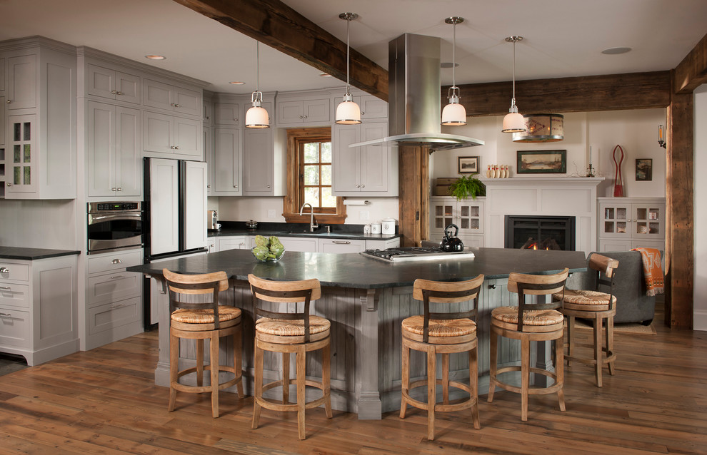 Design ideas for a rustic open plan kitchen in Other with shaker cabinets, grey cabinets, medium hardwood flooring, an island, a submerged sink and integrated appliances.