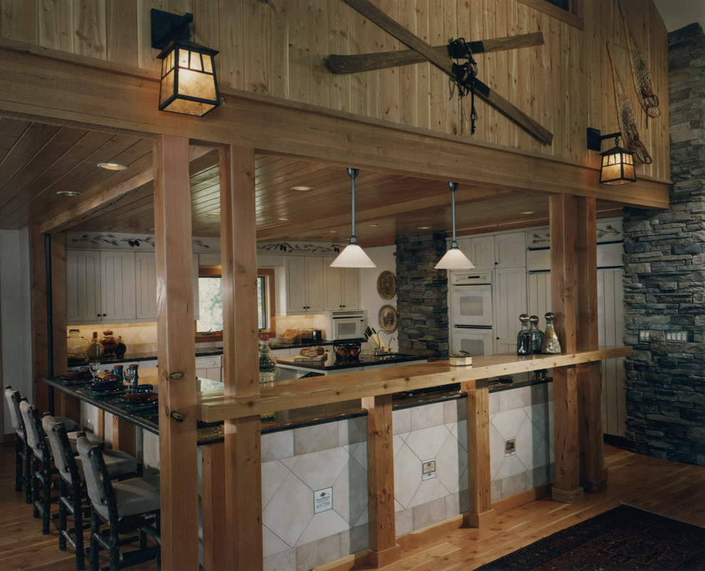 Enclosed kitchen - mid-sized rustic l-shaped light wood floor enclosed kitchen idea in Other with beaded inset cabinets, white cabinets, white backsplash, ceramic backsplash and two islands