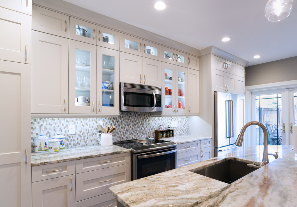 Small traditional galley kitchen/diner in DC Metro with a submerged sink, flat-panel cabinets, grey cabinets, granite worktops, grey splashback, mosaic tiled splashback, stainless steel appliances, medium hardwood flooring and a breakfast bar.