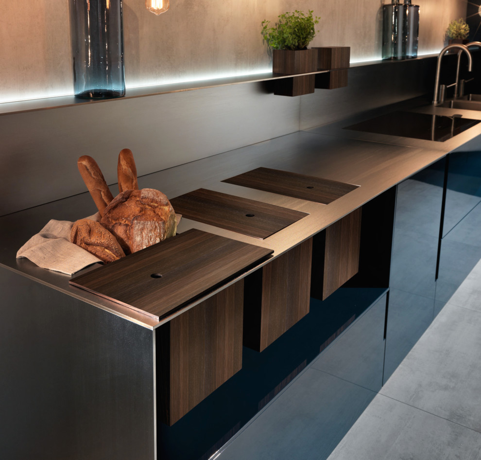 Inspiration for a large contemporary u-shaped open plan kitchen in Los Angeles with a double-bowl sink, flat-panel cabinets, blue cabinets, wood worktops, beige splashback, stainless steel appliances, concrete flooring and no island.