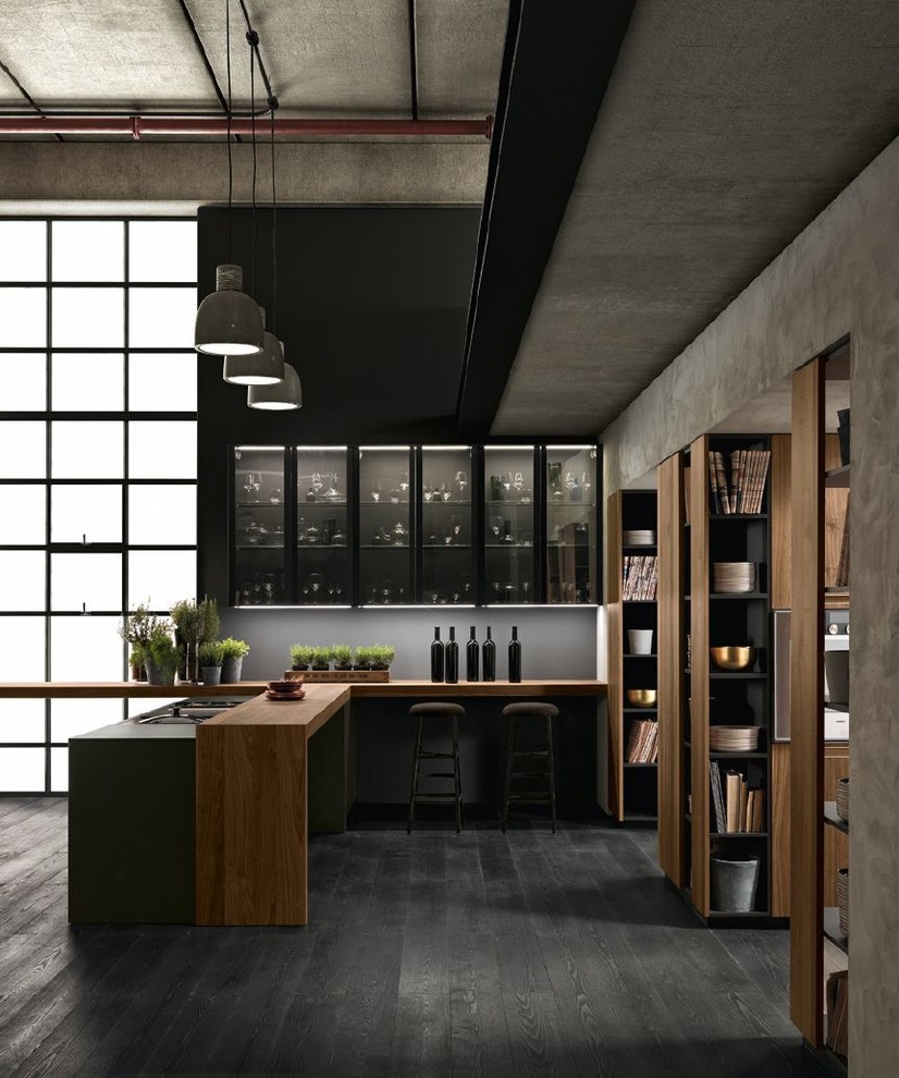 Inspiration for a large contemporary u-shaped kitchen/diner in San Francisco with an integrated sink, flat-panel cabinets, grey cabinets, wood worktops, grey splashback, black appliances, dark hardwood flooring, a breakfast bar, black floors and brown worktops.