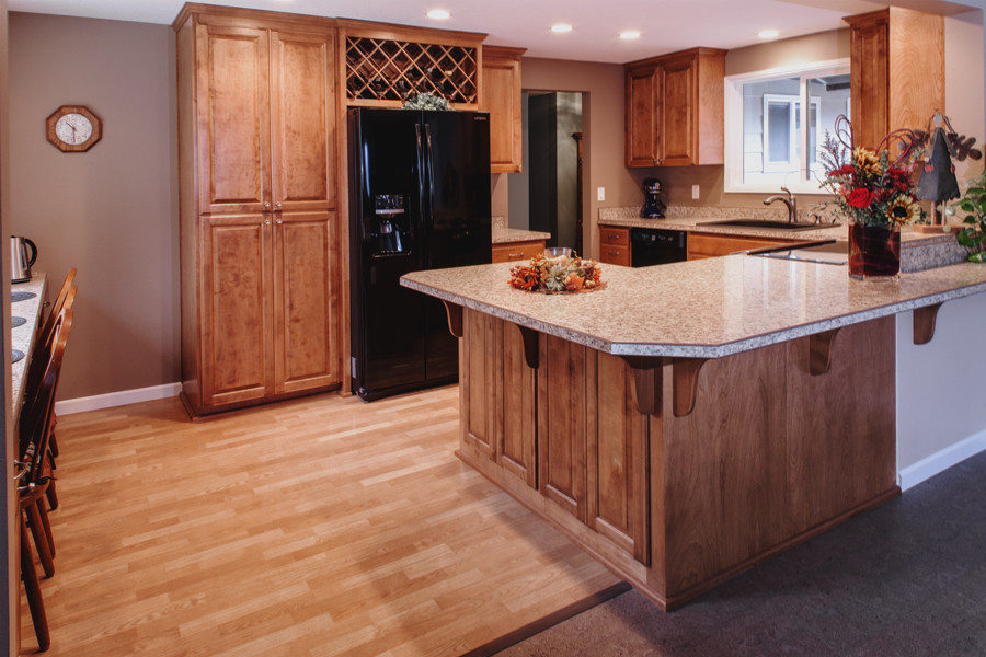 Arts and crafts u-shaped eat-in kitchen photo in Portland with an undermount sink, raised-panel cabinets, medium tone wood cabinets, laminate countertops, multicolored backsplash and black appliances