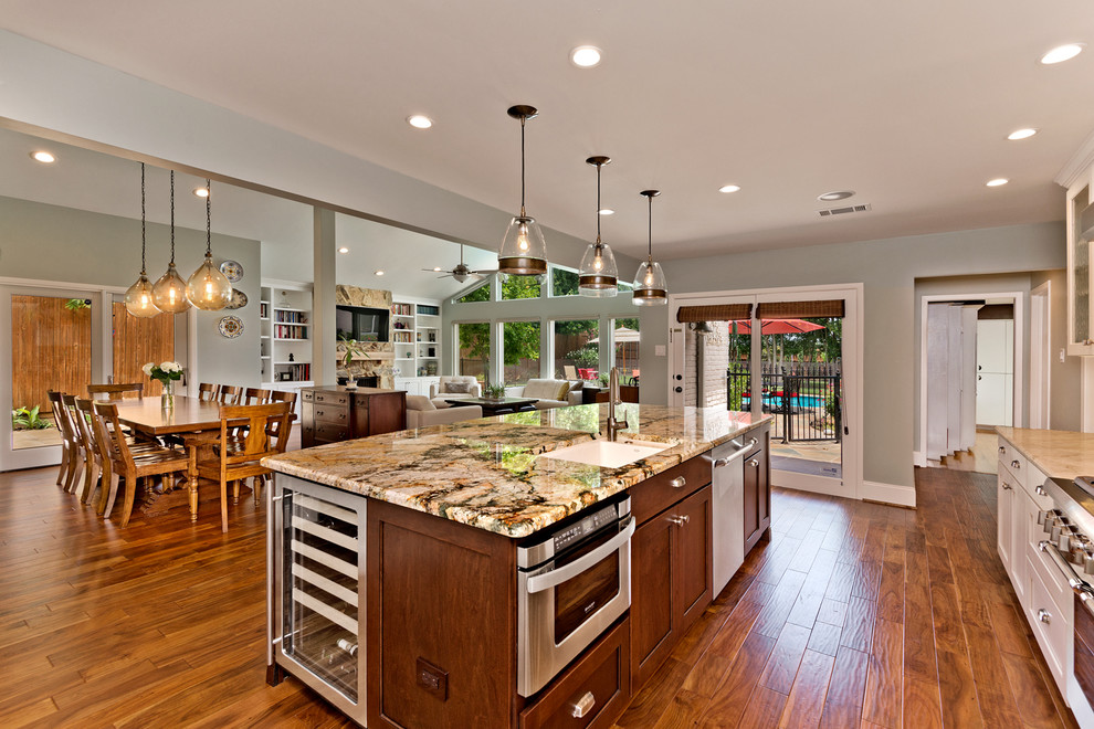 Large transitional medium tone wood floor eat-in kitchen photo in Dallas with an undermount sink, beaded inset cabinets, white cabinets, granite countertops, green backsplash, ceramic backsplash, stainless steel appliances and an island