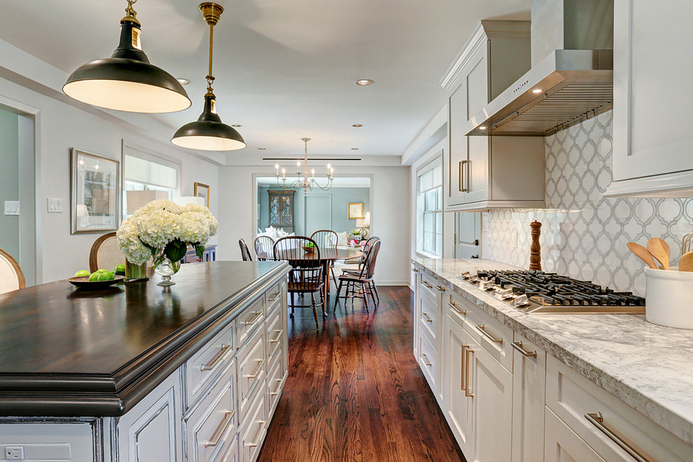 Inspiration for a traditional u-shaped kitchen/diner in Houston with a submerged sink, shaker cabinets, grey cabinets, marble worktops, white splashback, stainless steel appliances, an island and medium hardwood flooring.