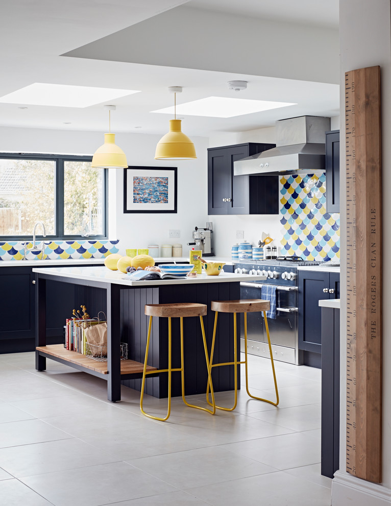 Cette image montre une cuisine ouverte design en L avec un placard à porte shaker, des portes de placard bleues et îlot.