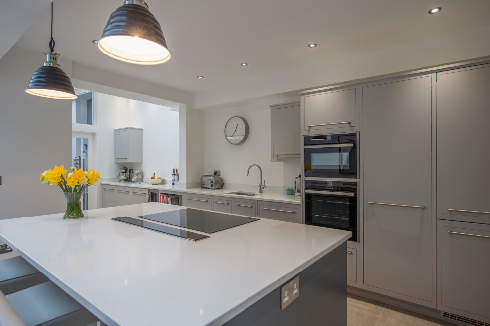 This is an example of a medium sized contemporary kitchen in Other with flat-panel cabinets, grey cabinets, granite worktops, an island and white worktops.