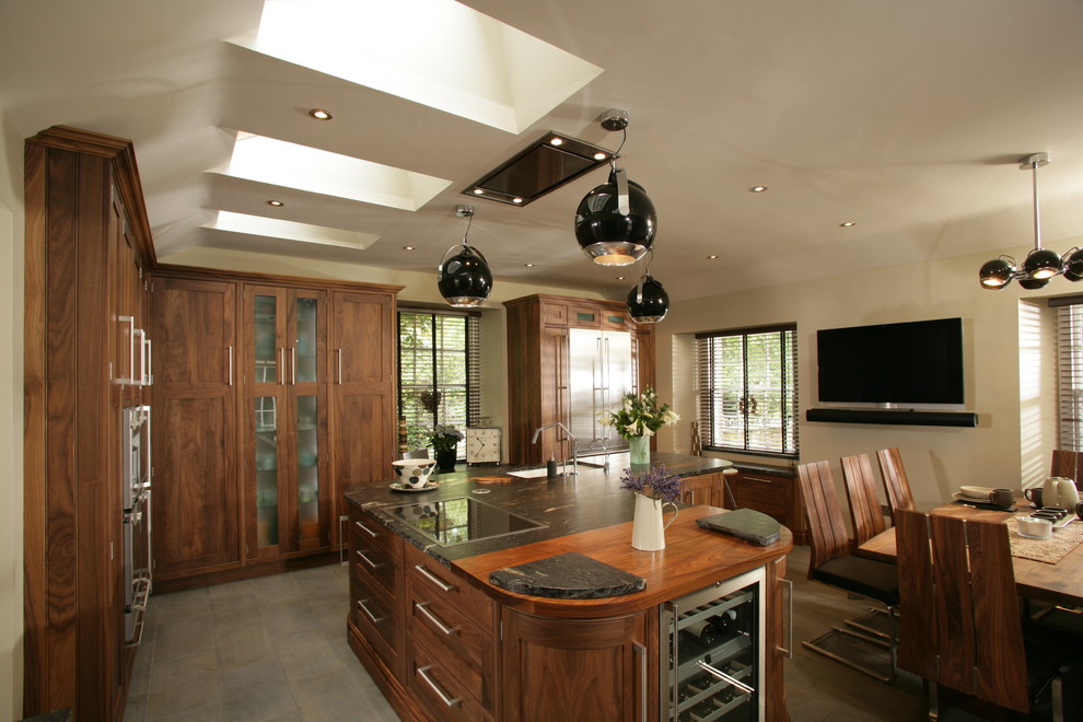 Photo of a contemporary kitchen in Edinburgh with granite worktops, stainless steel appliances and an island.