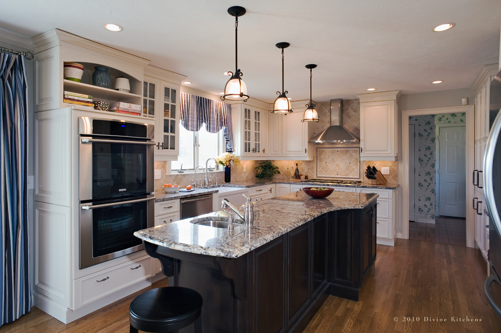 Kitchen - traditional kitchen idea in Boston with glass-front cabinets, stainless steel appliances and granite countertops