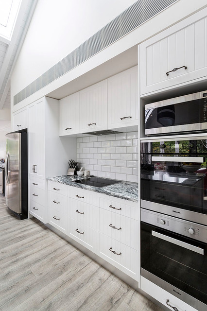 Black and white granite benchtop with white cabinets - Country ...