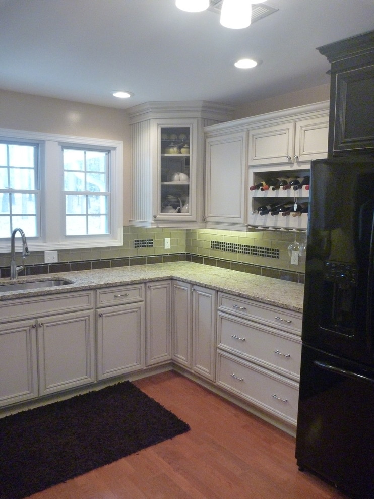 Example of a classic kitchen design in Atlanta with an undermount sink, recessed-panel cabinets and granite countertops