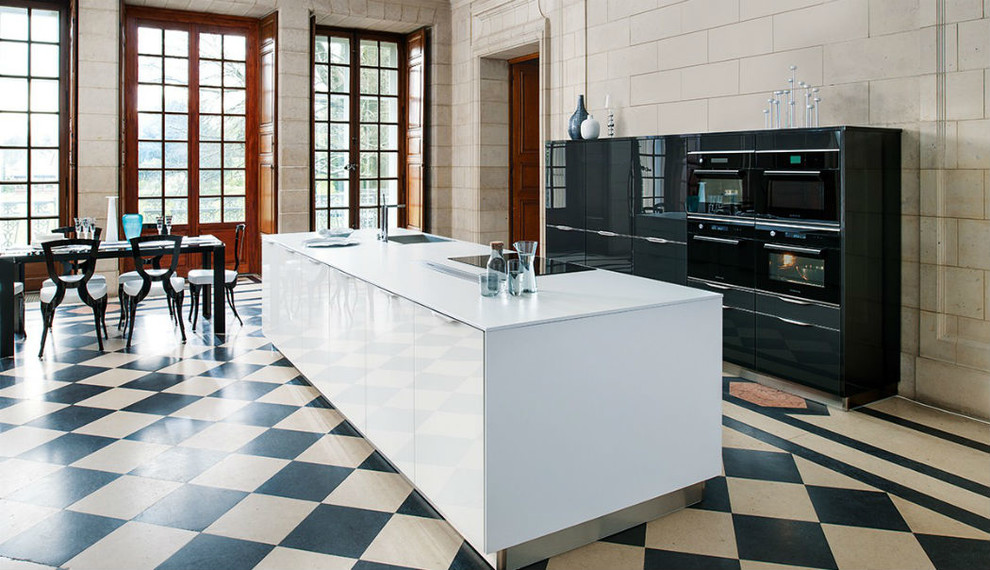 Photo of a large contemporary single-wall open plan kitchen in London with flat-panel cabinets and an island.