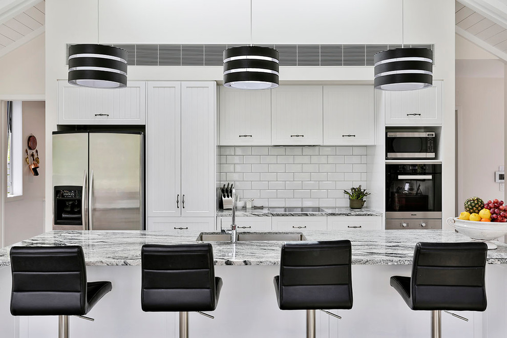 Black and white pendant lights above the main island Country