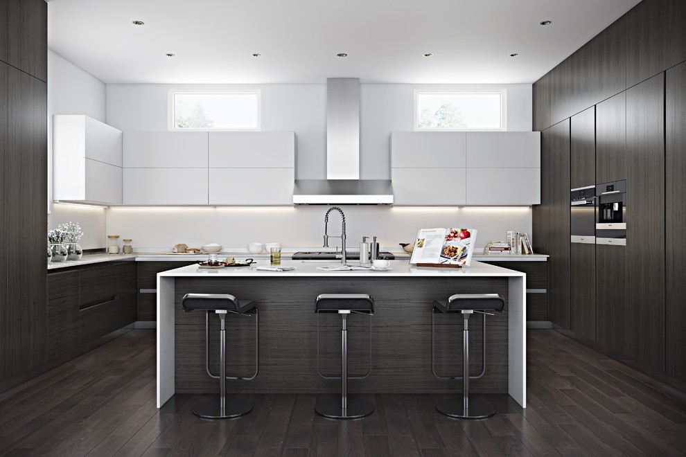 This is an example of a large modern u-shaped kitchen/diner in Los Angeles with an integrated sink, flat-panel cabinets, white cabinets, composite countertops, white splashback, glass sheet splashback, integrated appliances, dark hardwood flooring, an island, brown floors and white worktops.