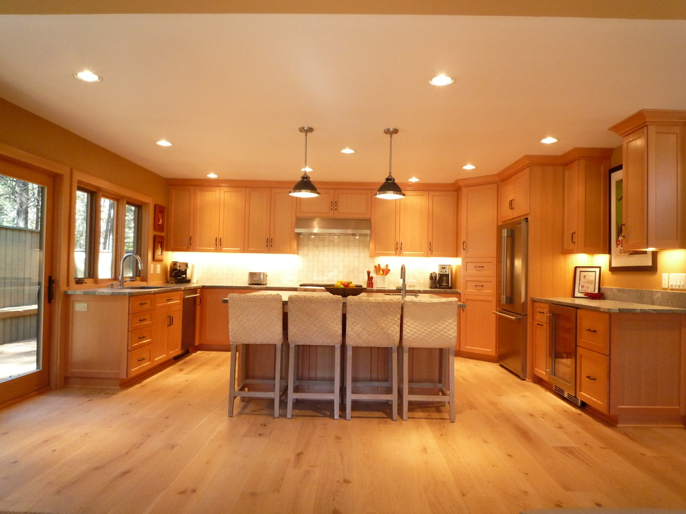Large mountain style u-shaped light wood floor eat-in kitchen photo in Portland with an undermount sink, shaker cabinets, light wood cabinets, granite countertops, beige backsplash, mosaic tile backsplash, stainless steel appliances and an island