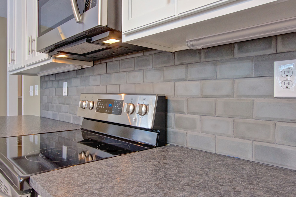 Idee per una cucina minimalista con paraspruzzi con piastrelle di cemento