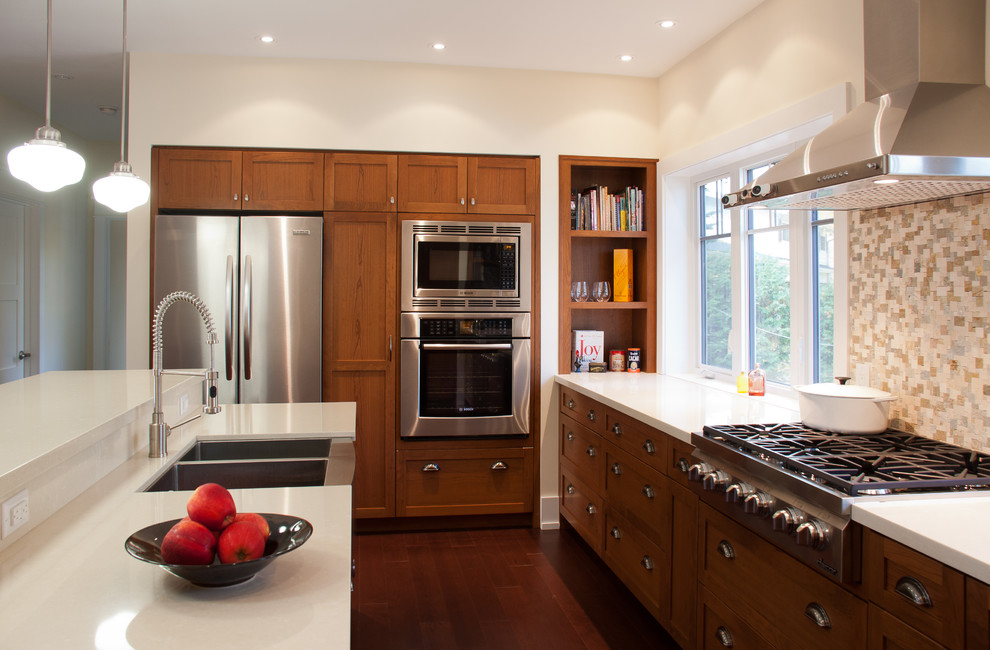 Elegant galley open concept kitchen photo in Toronto with recessed-panel cabinets and medium tone wood cabinets