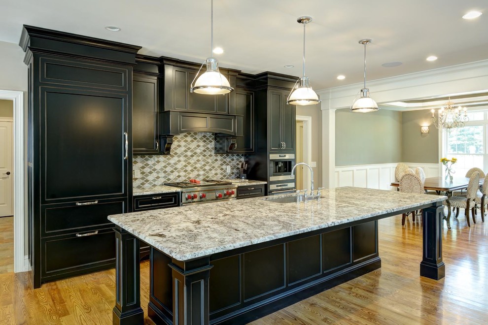 Example of a large classic galley light wood floor and brown floor eat-in kitchen design in Boston with black cabinets, granite countertops, stainless steel appliances, an island, an undermount sink, multicolored backsplash, mosaic tile backsplash and shaker cabinets