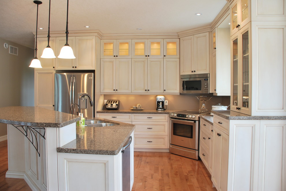 Example of a mid-sized transitional l-shaped light wood floor open concept kitchen design in Other with an undermount sink, flat-panel cabinets, distressed cabinets, quartz countertops, stainless steel appliances and an island