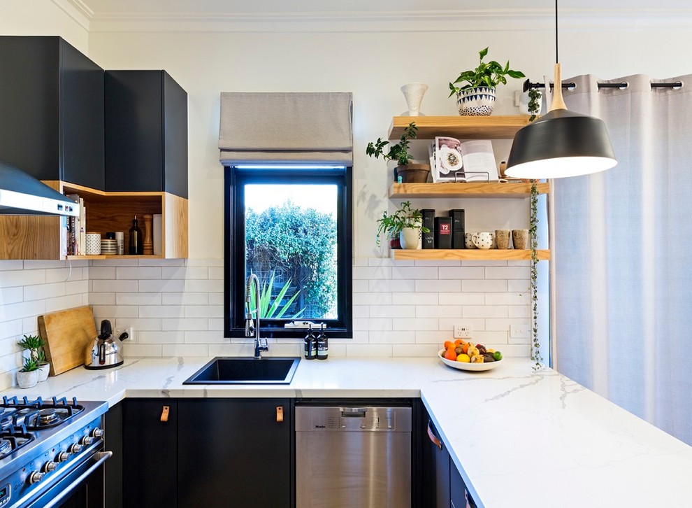 Design ideas for a medium sized contemporary u-shaped kitchen/diner in Melbourne with a single-bowl sink, flat-panel cabinets, black cabinets, engineered stone countertops, white splashback, ceramic splashback, stainless steel appliances, light hardwood flooring, no island, yellow floors and white worktops.