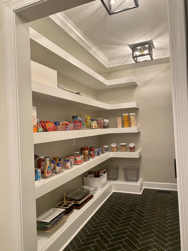 Photo of a small modern single-wall kitchen pantry in Atlanta with flat-panel cabinets, white cabinets and an island.
