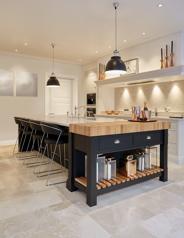 Inspiration for a large contemporary single-wall enclosed kitchen in Manchester with a belfast sink, beaded cabinets, black cabinets, composite countertops, white splashback, stone slab splashback, stainless steel appliances, marble flooring and an island.