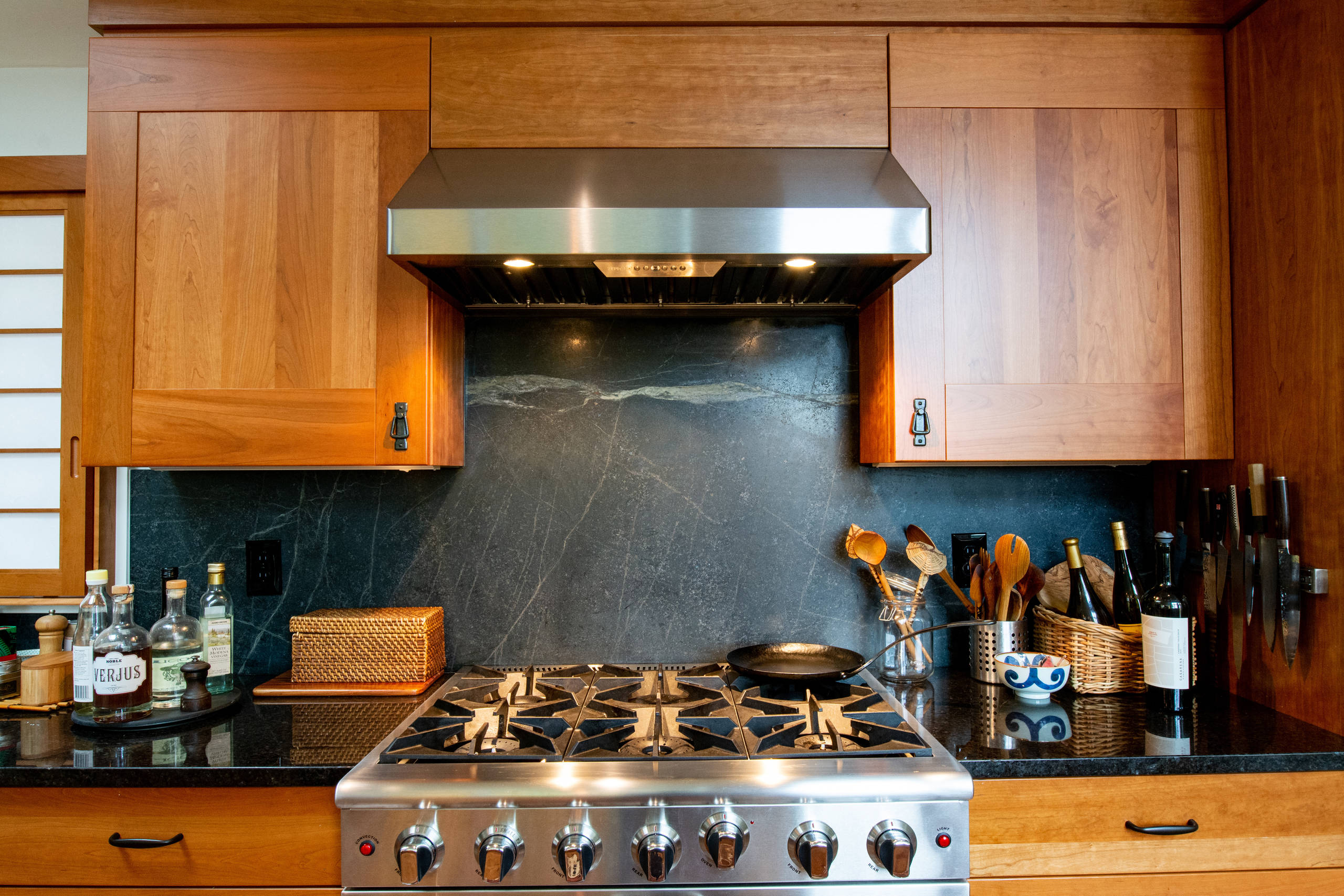 Backsplash Ideas - full height granite backsplash behind cooktop