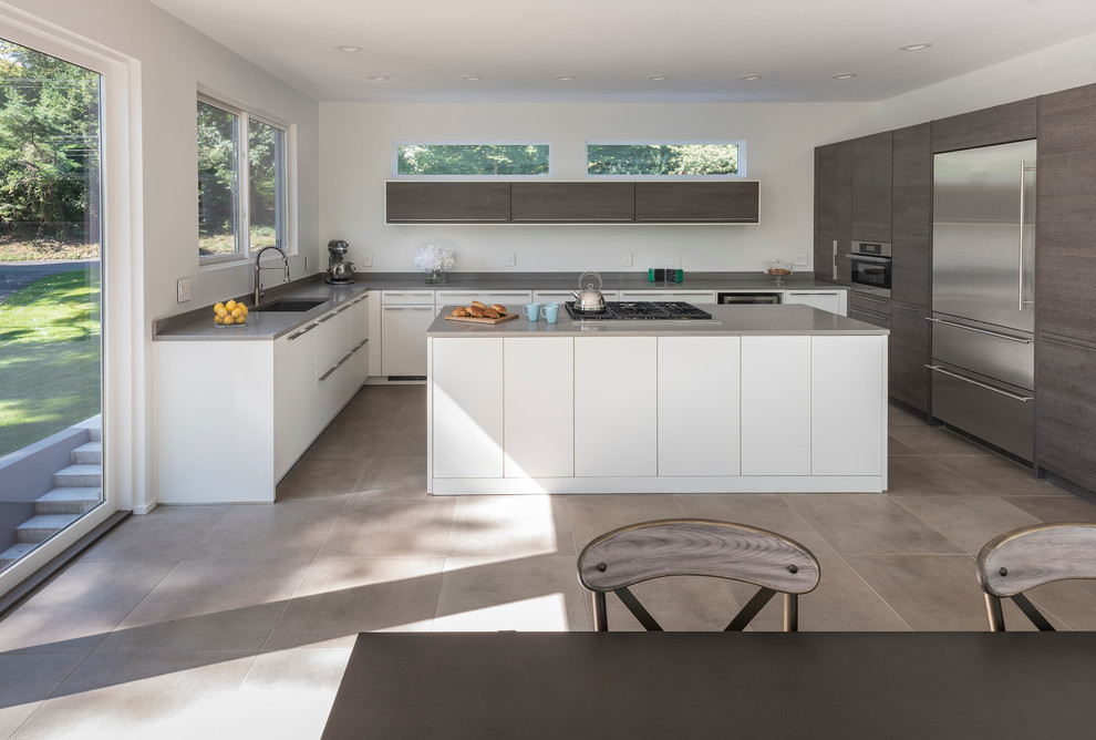 Medium sized contemporary u-shaped kitchen/diner in Other with a submerged sink, flat-panel cabinets, dark wood cabinets, stainless steel appliances, an island, quartz worktops, grey floors and grey worktops.