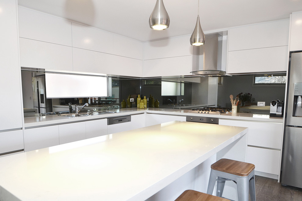 Contemporary kitchen in Melbourne with grey splashback and mirror splashback.